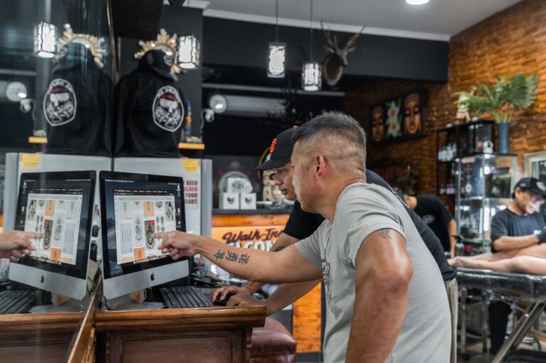 Tattoo artist discussing a custom design with a client at MR Dolphin Tattoo