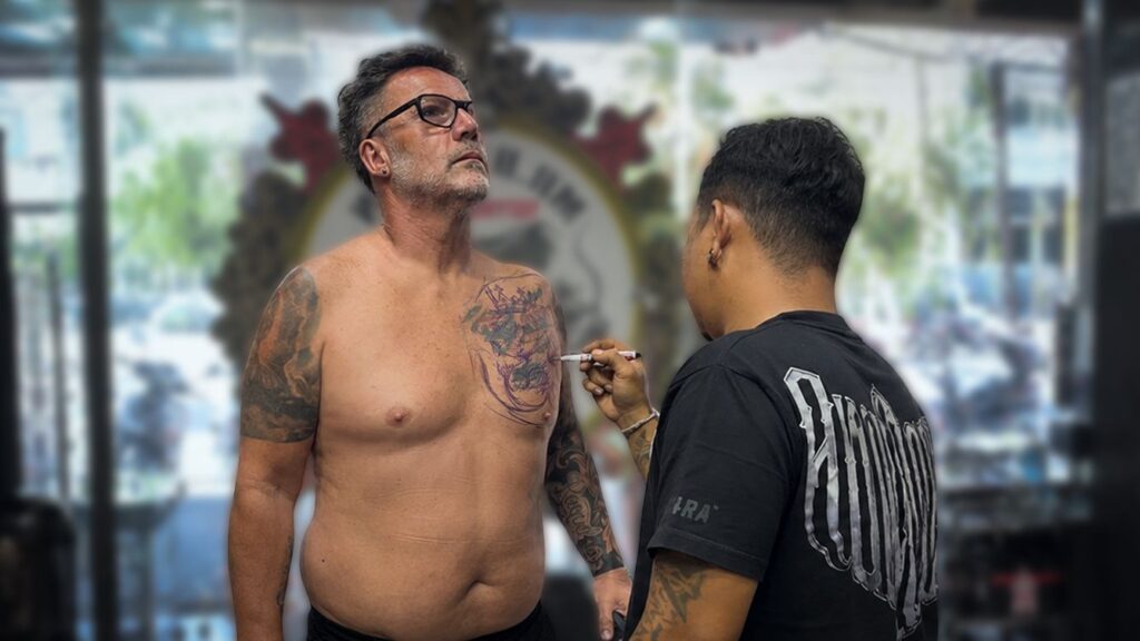 Client discussing how to change an old tattoo with a tattoo artist in Bali