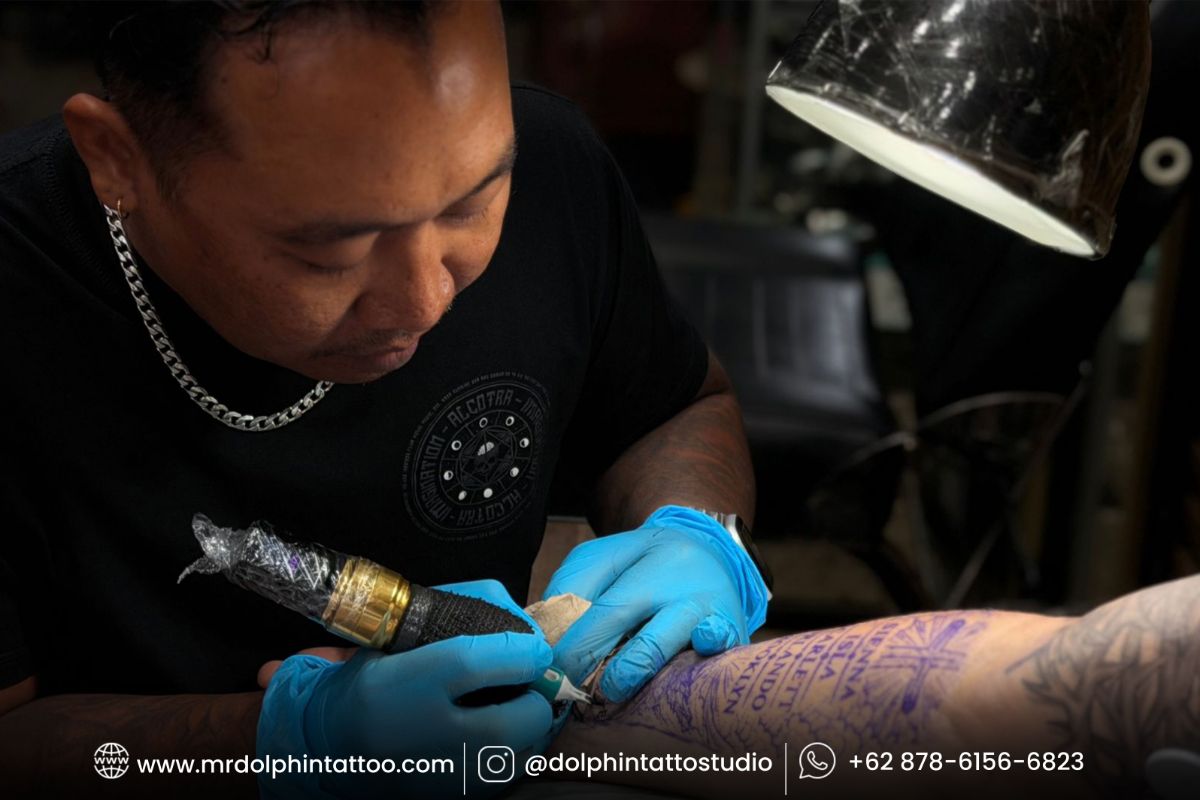 Client reviewing a tattoo artist portfolio before choosing a tattoo style in Bali
